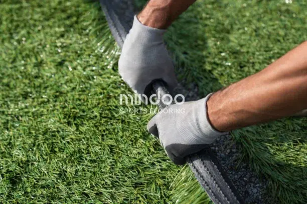 Installing football artificial turf Installing football artificial turf
