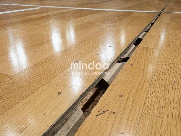 Cracks appeared in the sports wood flooring due to excessive humidity. Cracks appeared in the sports wood flooring due to excessive humidity.