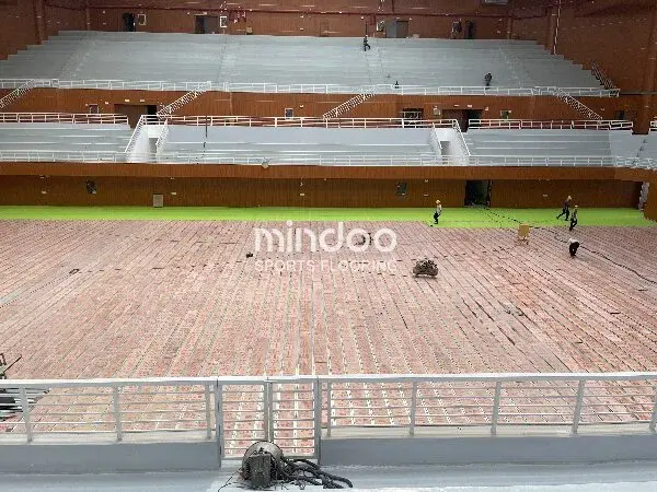 Professional installation of wooden gymnasium flooring.